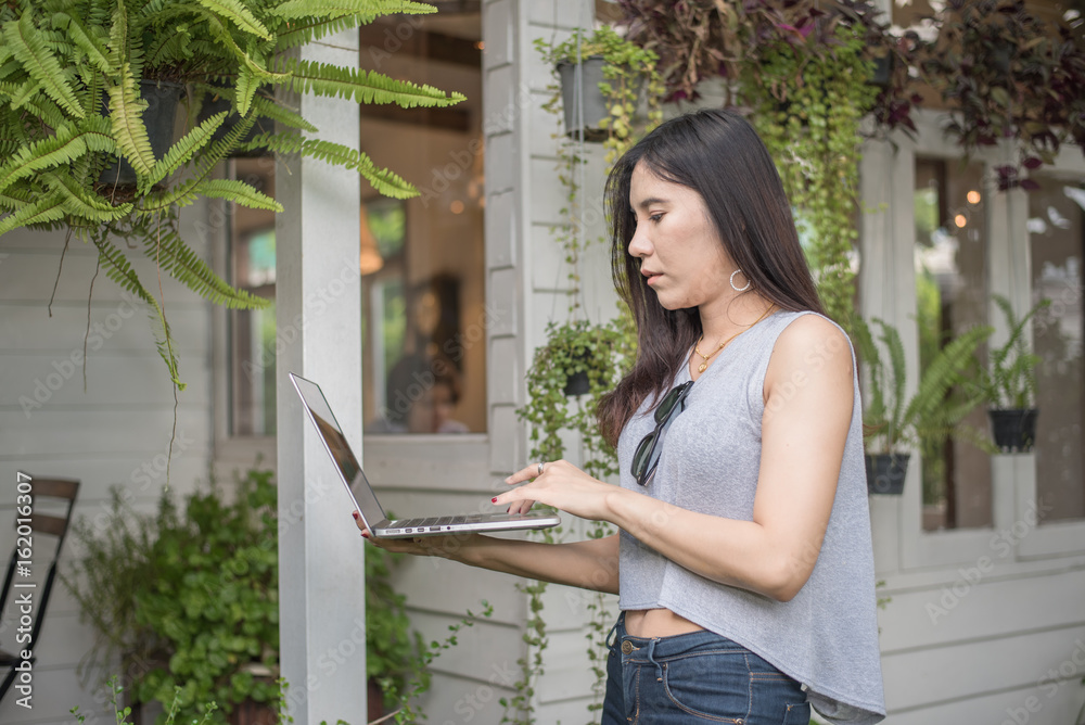 Beautiful young woman using laptop in coffee shop Beautiful young woman using laptop in coffee shop