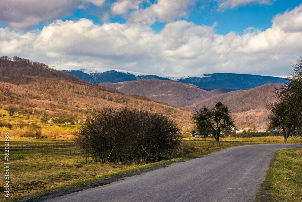 countryside road through valley to village