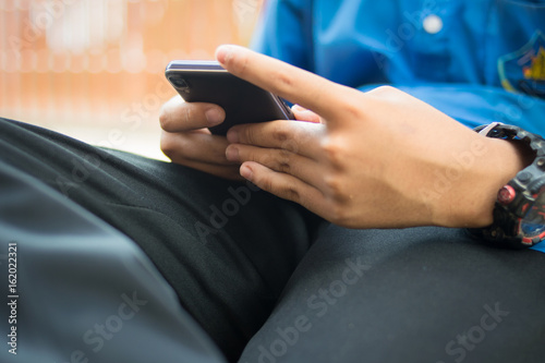 student sitting and using smartphone