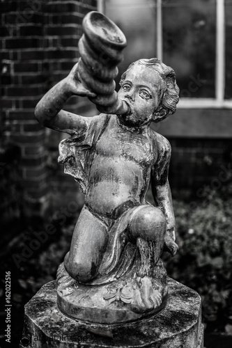 boy statue with blow horn