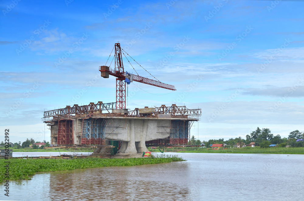 Fototapeta premium Construction of bridges over the river