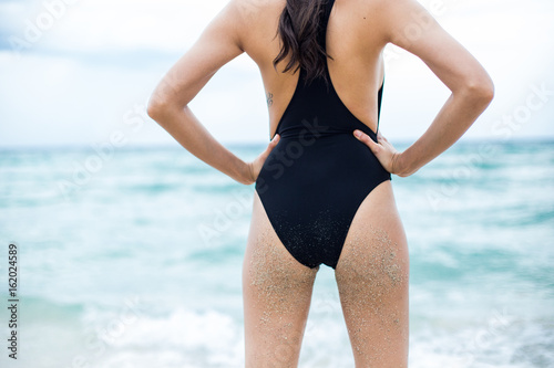 Back view of a young woman in swimsuit