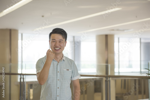 Young man cheering and rising his arms. Free Download Young man cheering and rising his arms. - GFXLoad