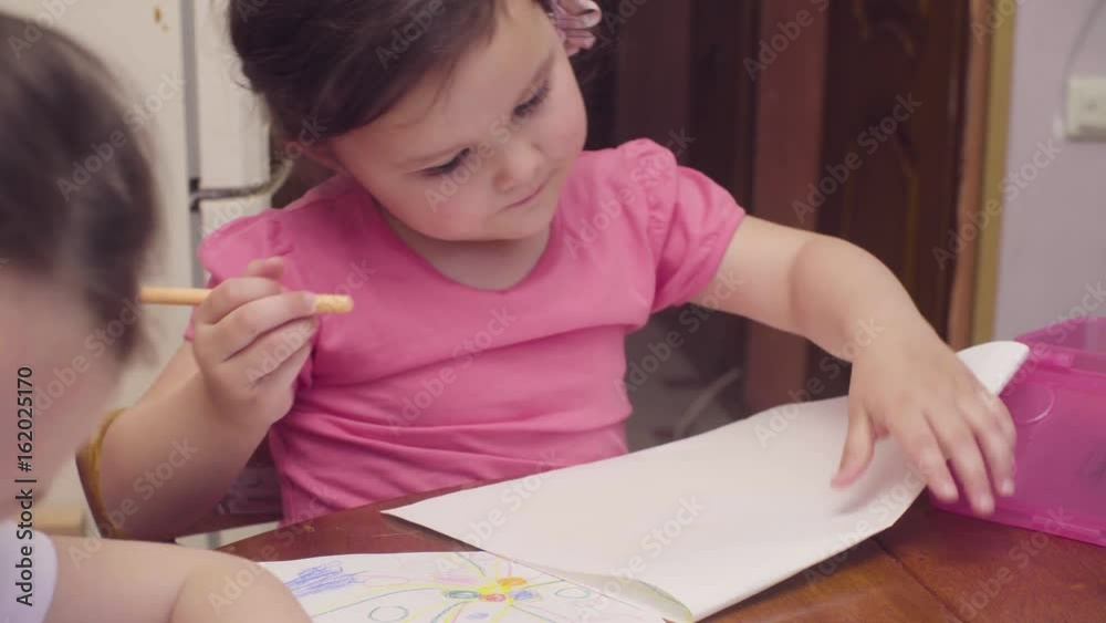 Little girl drawing at a table Little girl drawing at a table