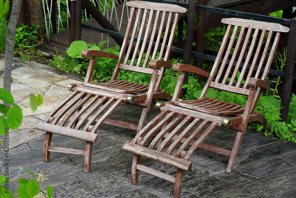 Pair of wooden reclining chairs