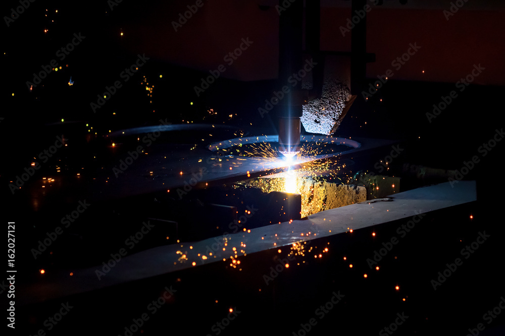 CNC plasma cutting machine during operation. CNC plasma cutting machine during operation.