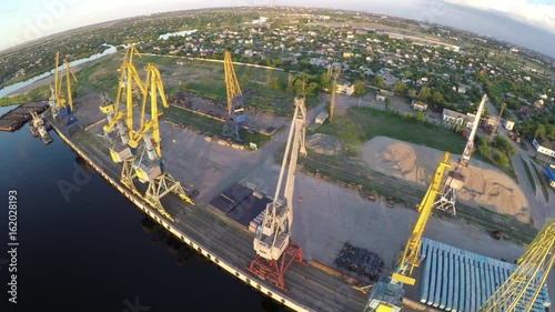  Port. Sunset. Dawn. Freight cranes. Aero video shooting. Shooting from the air. Ships.