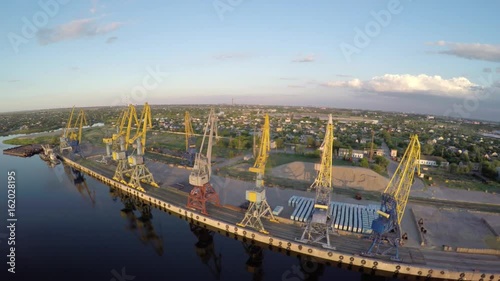  Port. Sunset. Dawn. Freight cranes. Aero video shooting. Shooting from the air. Ships.