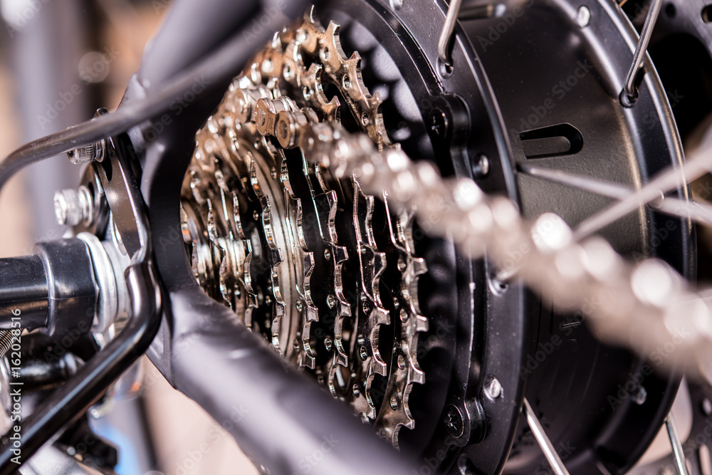 Obraz premium close up of bicycle gear and black electric motor
