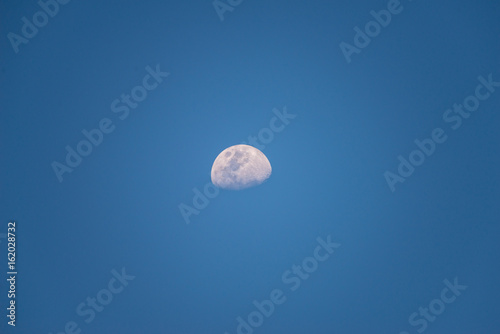 half moon with blue sky
