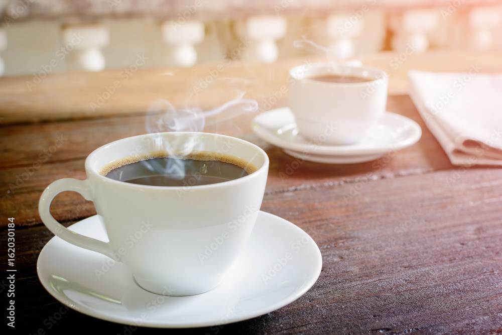 coffee cup clock and news paper on old wooden table nature background