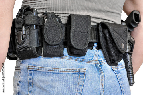 Military tactical belt with semi-automatic buckle for connection with cartridge pouch, placed on man's belt, isolated - back view