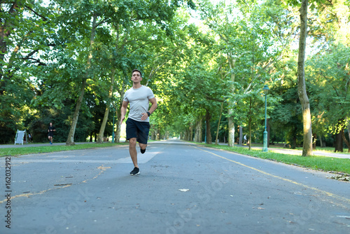 A handsome young man jogging in a park © Spectral-Design