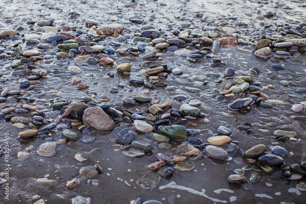 Obraz premium Wet pebbles and sand