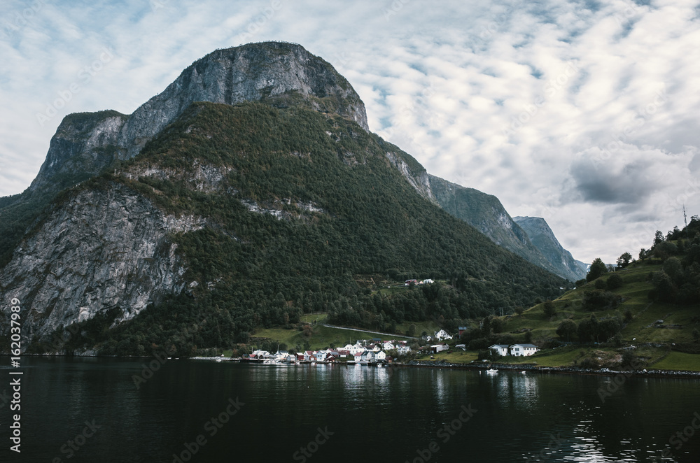 Sailing through Sognefjord, Norway. Picturesque small village on the way to Flam