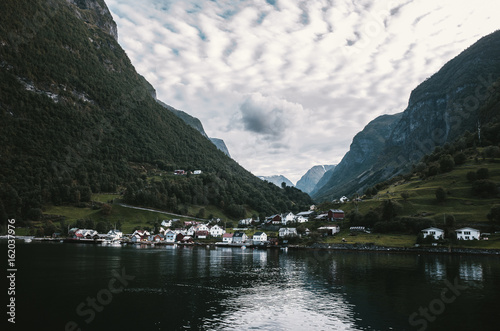 Sailing through Sognefjord, Norway. Picturesque small village on the way to Flam