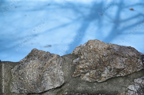Old stone wall texture with blue background
