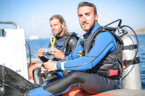 Two scuba diver sitting on a boat