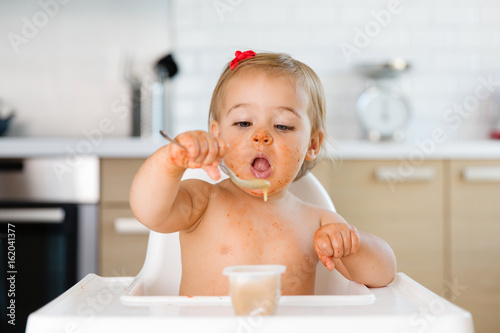 toddler learning to eat with a spoon