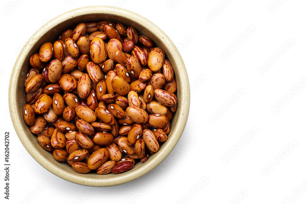 Pile of dark speckled kidney beans in bowl. Top view Pile of dark speckled kidney beans in bowl. Top view