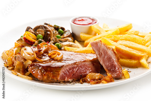 Grilled beef steak with french fries on white background 