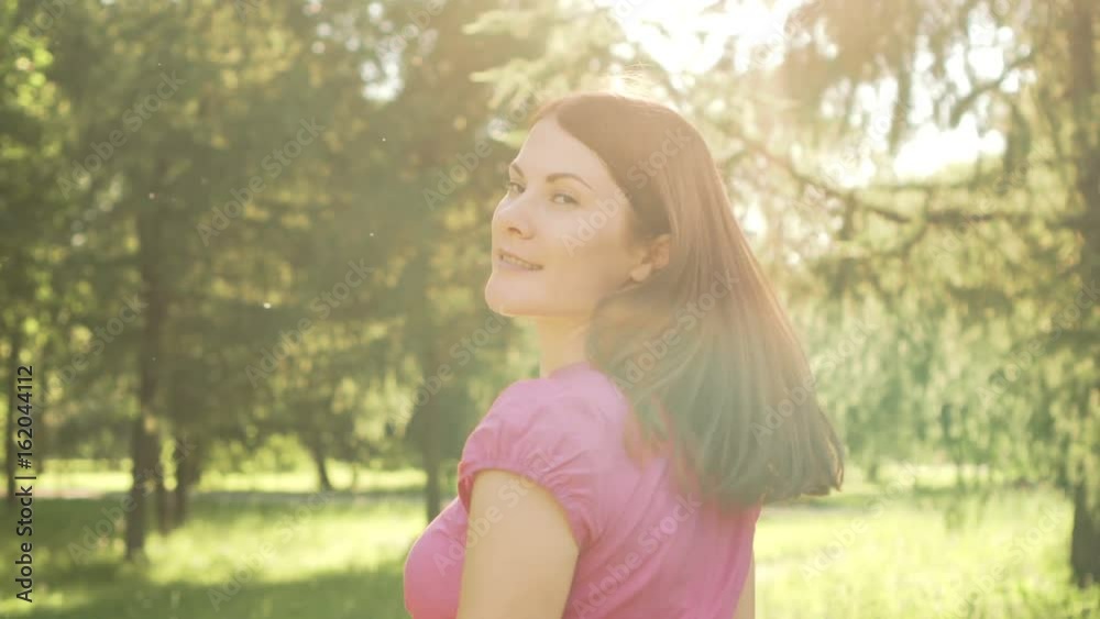Slow Motion Pov Woman walking in park, relaxing summer vacation, turn and smile. Camera following behind Slow Motion Pov Woman walking in park, relaxing summer vacation, turn and smile. Camera following behind
