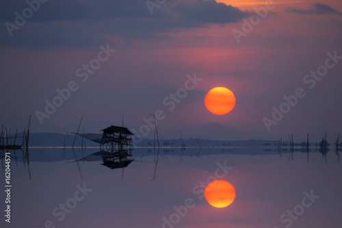 Mirror image of Sunset at the lake, Thailand.