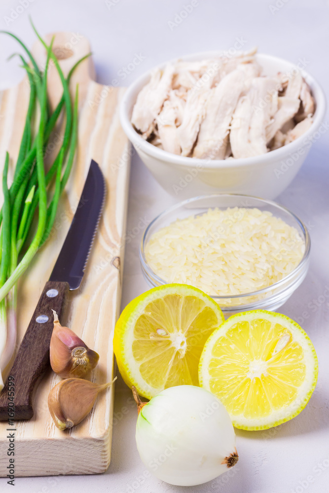 Fresh ingredients for avgolemono - traditional soup with lemon, chicken, orzo, rice or couscous. Fresh ingredients for avgolemono - traditional soup with lemon, chicken, orzo, rice or couscous.