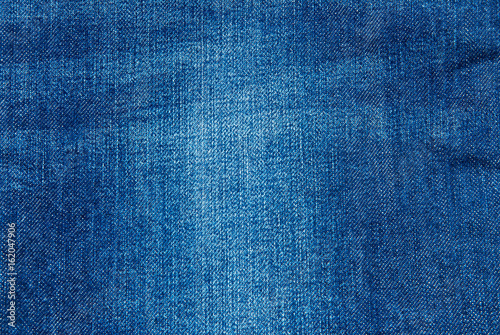 Texture of blue jeans textile close up