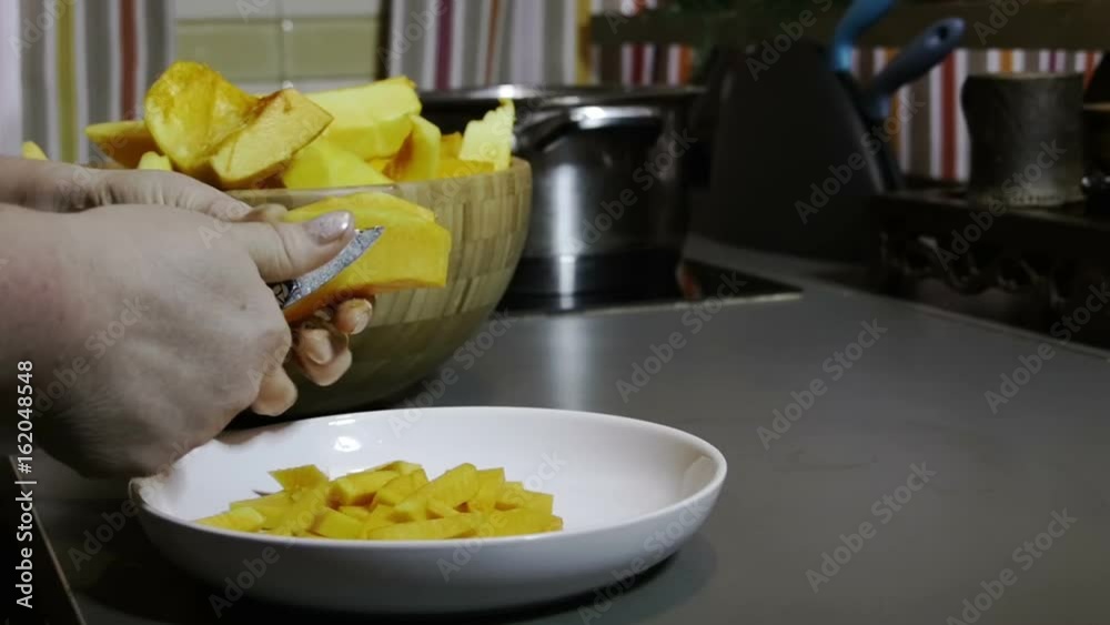Woman slices a pumpkin slow motion Woman slices a pumpkin slow motion