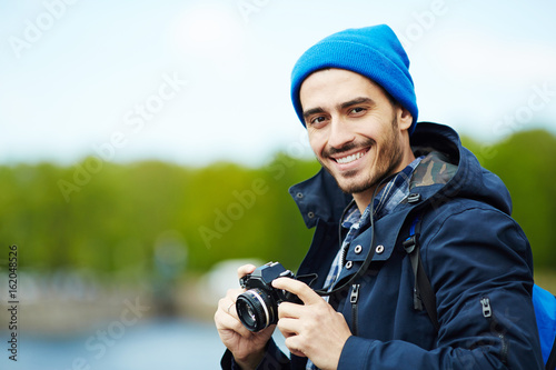 Young modern blogger with photocamera