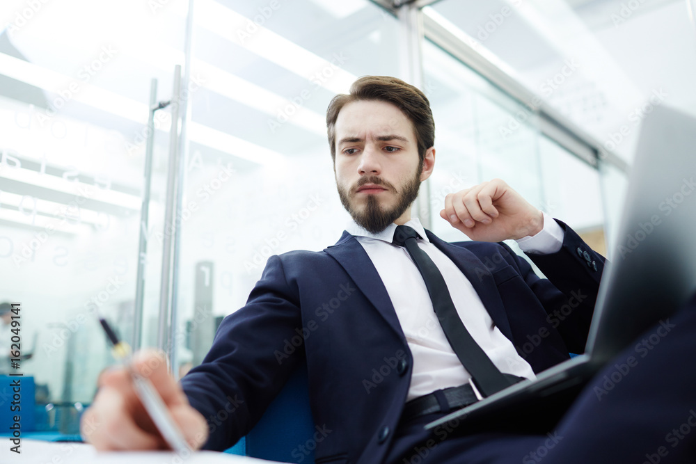 Fototapeta premium Busy salesman reading financial papers