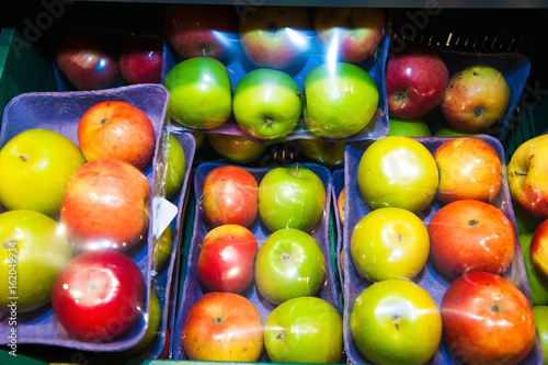 Apples on boxes in supermarket