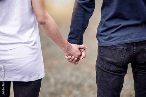 Close up view of a romantic senior couple holding hands