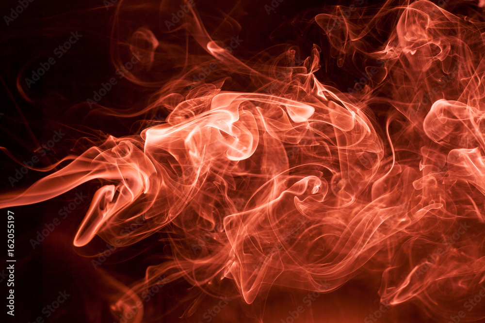Fototapeta premium Red smoke on a black background.