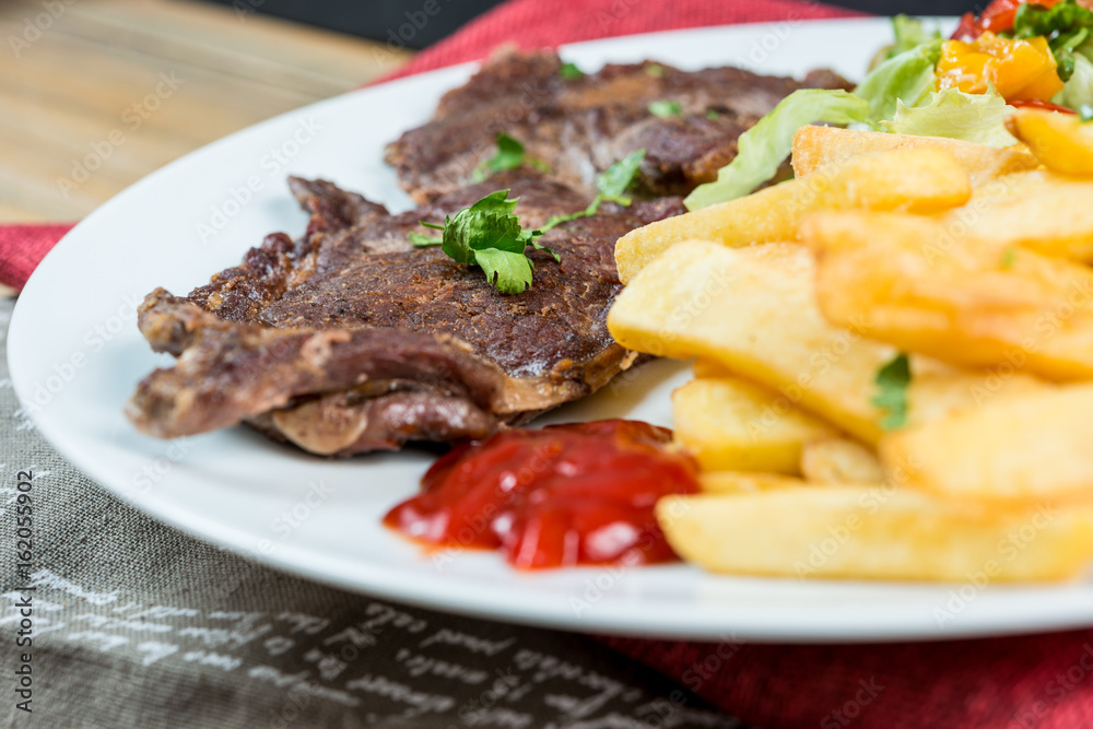 juicy steak beef meat with tomato and french fries