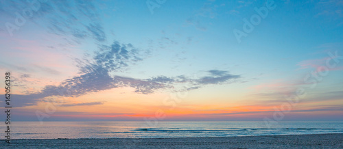 Sunrise over sea and sandy beach in spring © Naj