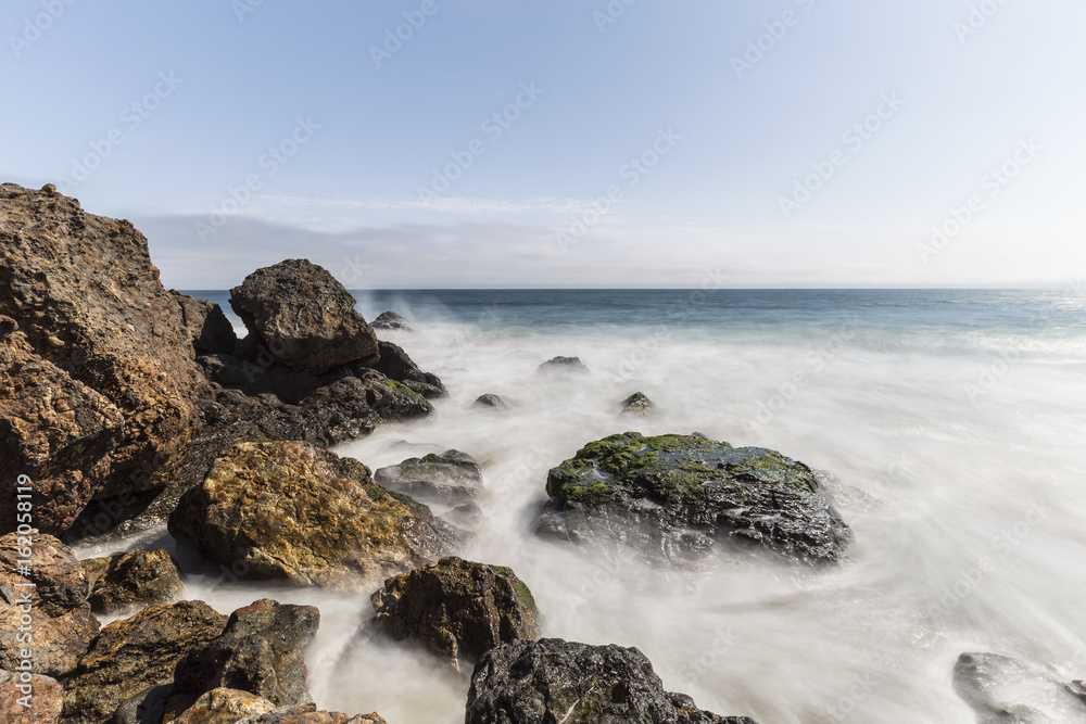 Pacific coast rocks and waves with motion blur at Point Dume in Malibu, California. Pacific coast rocks and waves with motion blur at Point Dume in Malibu, California.