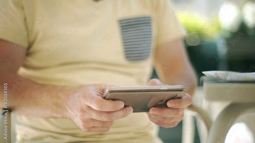 Man holding smartphone and typing something on it, steadycam shot
Man holding smartphone and typing something on it, steadycam shot