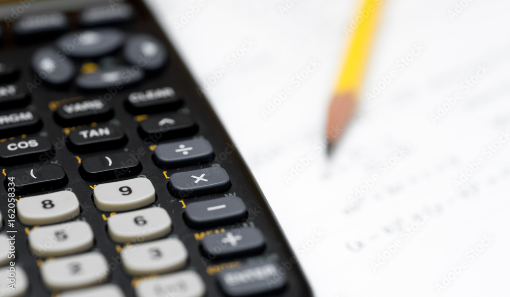 calculator and pencil isolated on a white background