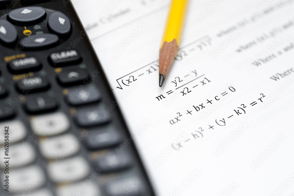 calculator and pencil isolated on a white background calculator and pencil isolated on a white background