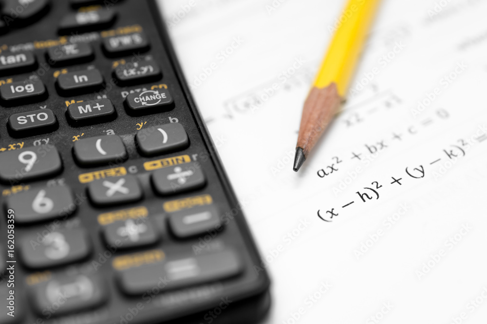 calculator and pencil isolated on a white background calculator and pencil isolated on a white background
