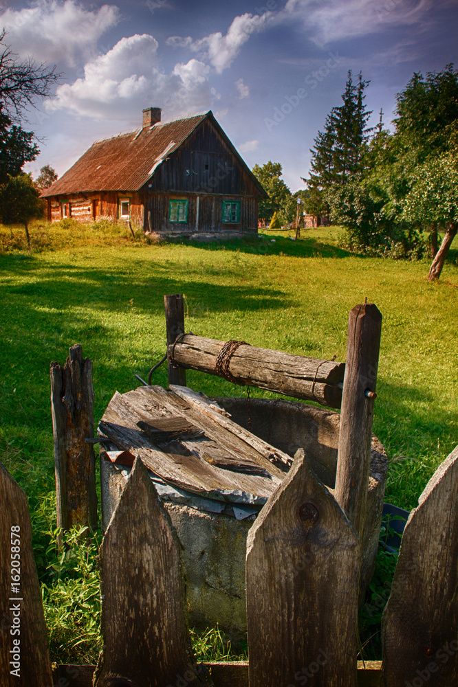 Old well and house