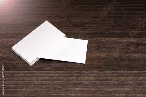 blank business cards isolated on a dark wooden background