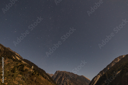 Mountain with little snow on the top with stars in the night at Lachen in North Sikkim, India.