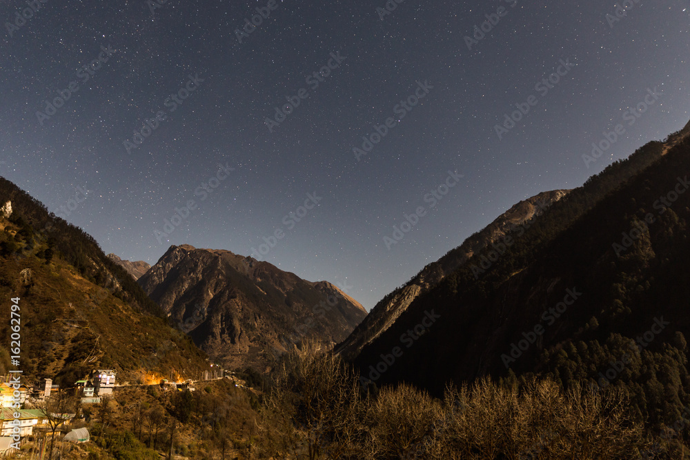 Mountain with little snow on the top with stars in the night at Lachen in North Sikkim, India.