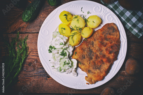 Pork cutlet with potatoes and cucumber salad