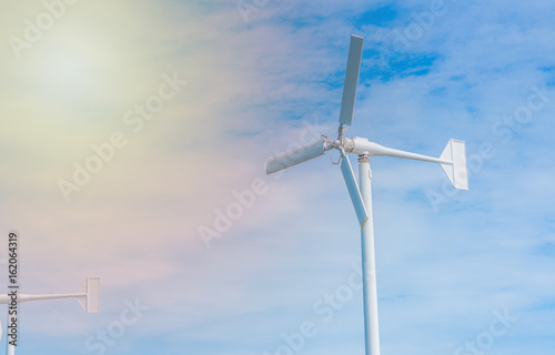 Wind Turbine for Electric with blue sky background © Kittichet