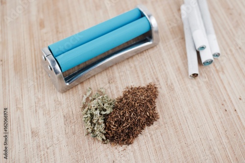 Marijuana and rolling machine.