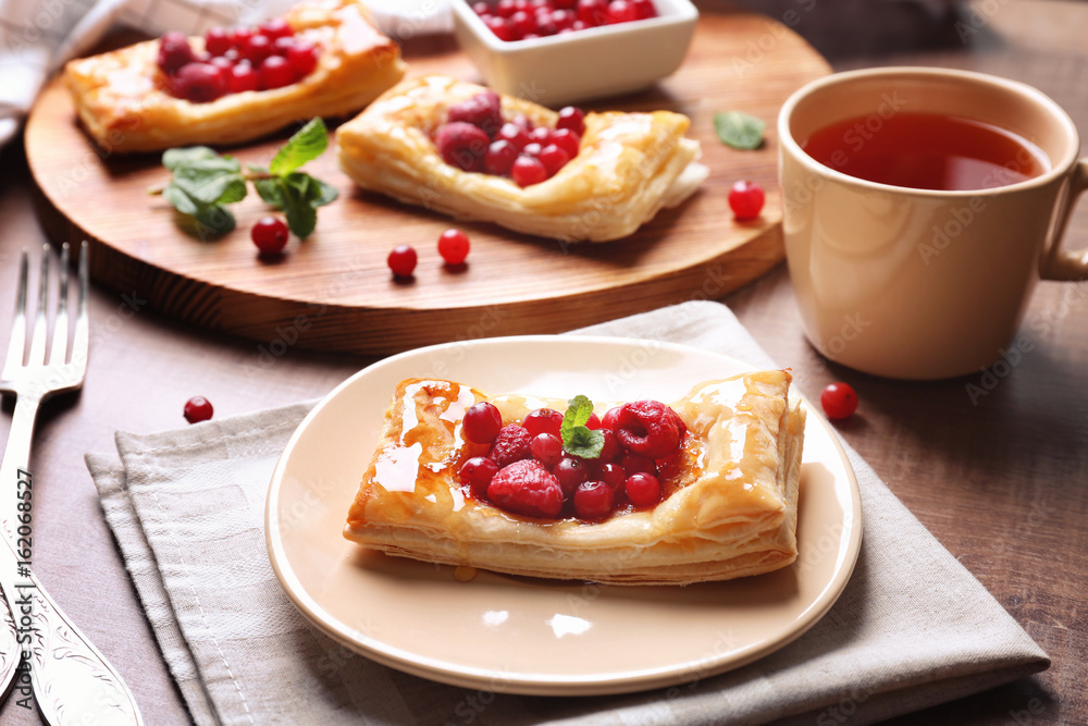 Delicious pastries with berries on served table Delicious pastries with berries on served table